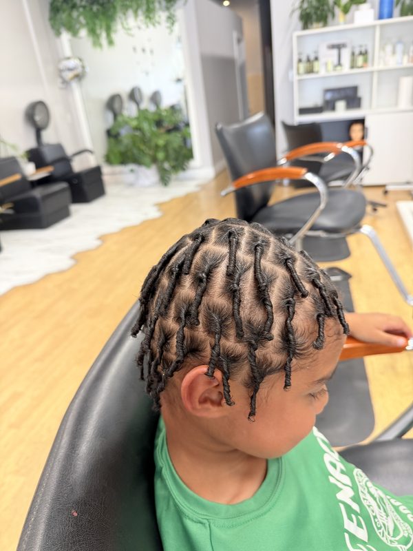 Starter locs on a child, side view